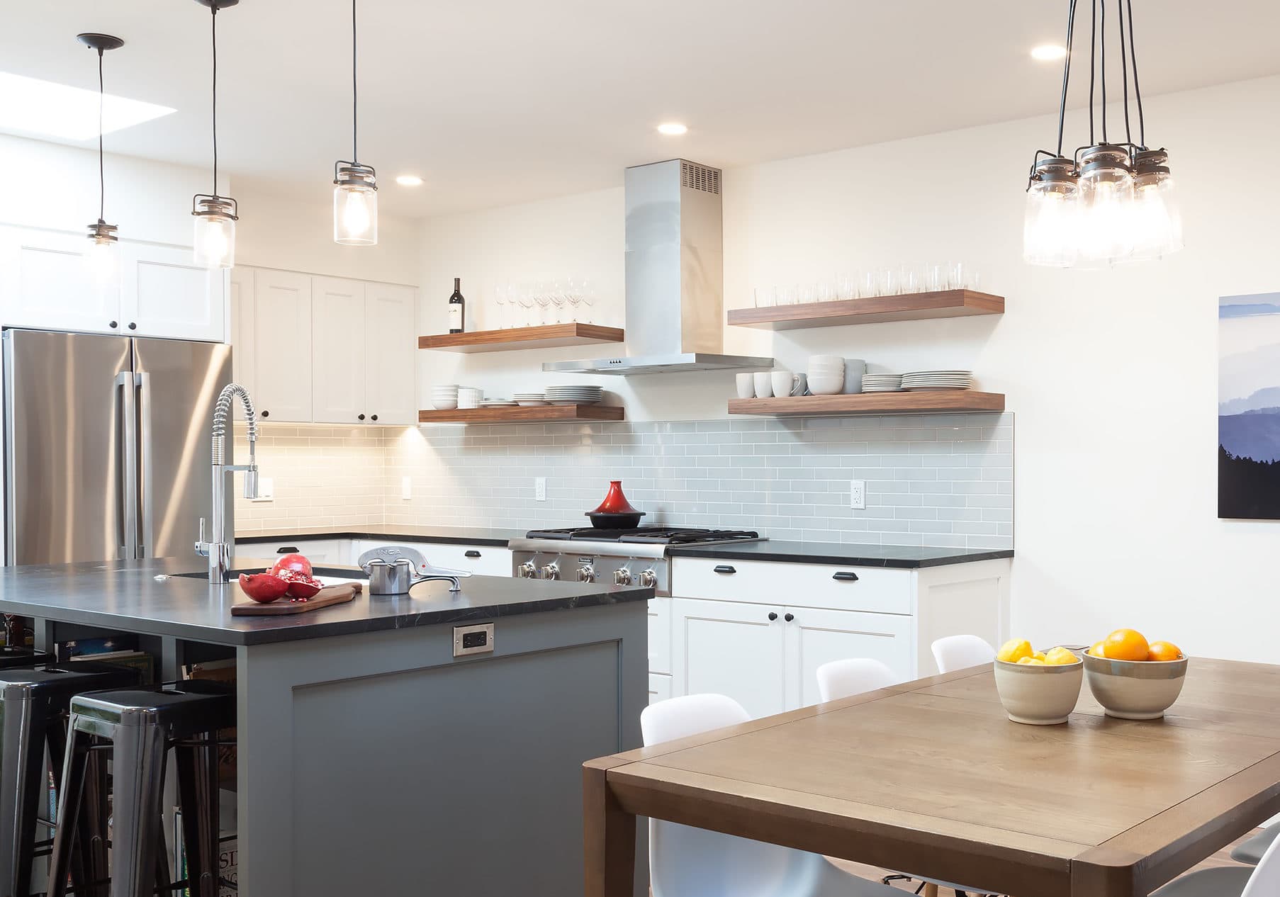 Black walnut floating shelves in a white kitchen